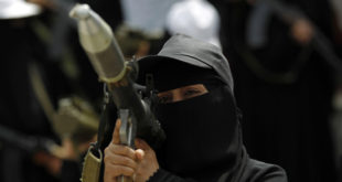 A Yemeni fighter supporting the Shiite Houthi rebels stands holding a rocket-propelled grenade (AFP)